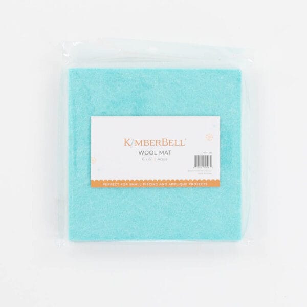 Packaged aqua wool mat on a white background