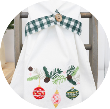 Circle Image, Closeup of Baubles & Boughs Teat Towel and on-the-hoop buttonholes.